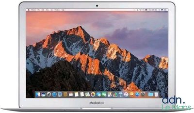 an apple macbook air laptop computer with a mountain in the background