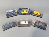 six toy cars are in plastic boxes on a table