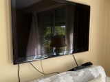 a flat screen tv mounted on the wall above a couch