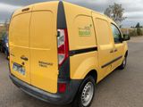 a yellow van that is parked in a parking lot