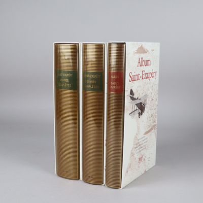 three books are stacked on top of each other on a table