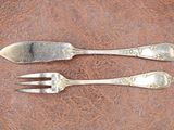 two forks and two spoons on a brown surface
