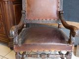a brown leather chair that is sitting on a tile floor
