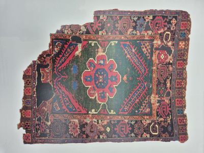 un tapis très ancien orné de nombreux motifs différents
