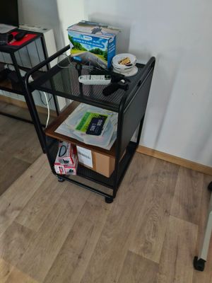 a small black cart with food on it in a room