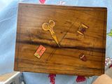 a wooden box that has a pair of scissors on it