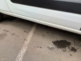 a white van parked in a parking lot next to a building