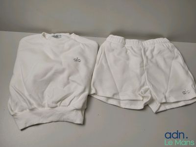 two pairs of white shorts sitting on top of a table