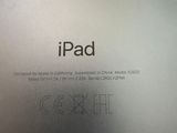 the back of an ipad sitting on a wooden table