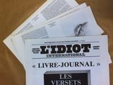 several newspapers are stacked on top of each other on a table