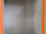 an orange and grey cabinet with a black cat on it
