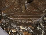 a bronze sculpture of a bird on a marble base