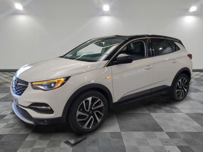 un SUV blanc garé dans un garage au sol carrelé