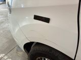 a close up of a white truck with a sticker on it ' s side