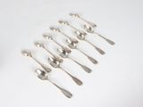 six spoons that are sitting on a white surface