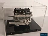 a small engine in a clear display case on a table