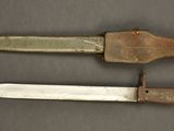 two knives are sitting next to each other on a table