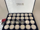 a box of silver coins sitting on top of a table