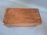 an old wooden box sitting on top of a white sheet