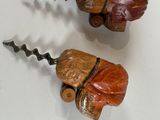 two pieces of wood that have been carved to look like acorns