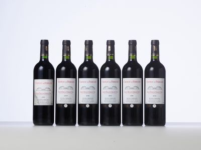 six bottles of wine are lined up on a table