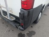 a white truck with a black bumper is parked in a parking lot
