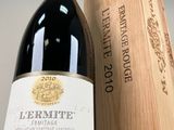a bottle of wine sitting next to a wooden box