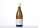 a bottle of white wine sitting on a table