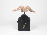 a clock that has a bird on top of it