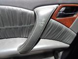a close up of a car door handle with a leather seat cover
