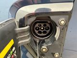 a close up of a gas pump with a car in the background