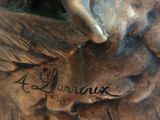 a bronze statue of a dog with a bird on it ' s head
