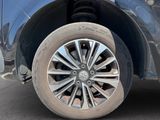 a close up of a tire on a blue car