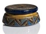 a small blue and gold box on a white surface