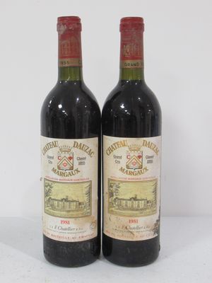 two bottles of wine sitting on top of a table next to each other