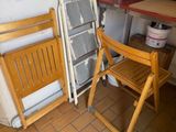 two folding chairs and a table in a room
