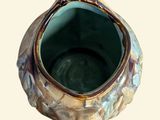 an image of a small vase with a bird on it