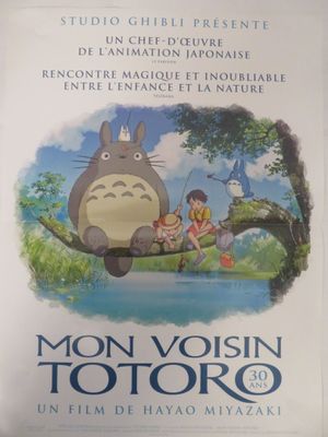 affiche du film du studio Ghihii, représentant Totoro et deux enfants assis sur une branche d'arbre