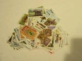 a pile of postage stamps on a white surface