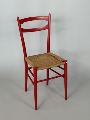 TRAVAIL ITALIEN. Chaise en bois laqué rouge, assise en corde…