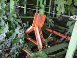 a green machine that is sitting in the grass