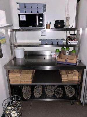 a kitchen with a stainless steel counter top and shelves