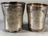 pair of antique silverplated cups with monograms on them