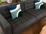 a living room with a couch, coffee table, and stairs