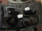 Plusieurs paires de lunettes de soleil sont exposées dans une vitrine.