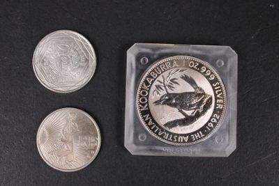 three coins and a coin sitting on a table next to each other