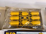a box with a bunch of yellow toy trains in it