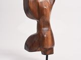 wooden sculpture of a woman ' s torso on a black stand