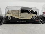 three model cars in a display case on a table