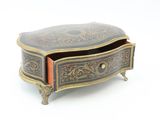 a small wooden box with an ornate design on it